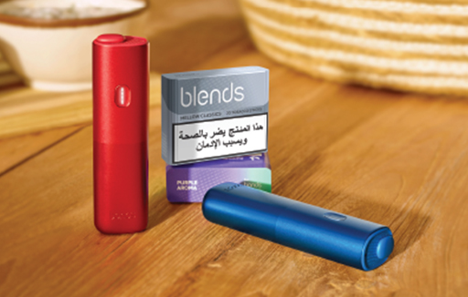 Hand holding a blue BONDS by IQOS heated tobacco device